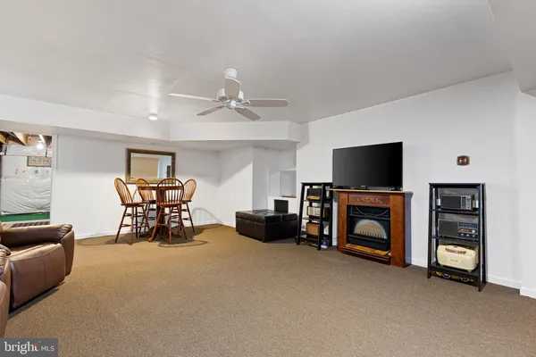 a bedroom with furniture and a ceiling fan