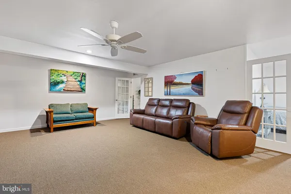 a view of a livingroom with furniture and a potted plant