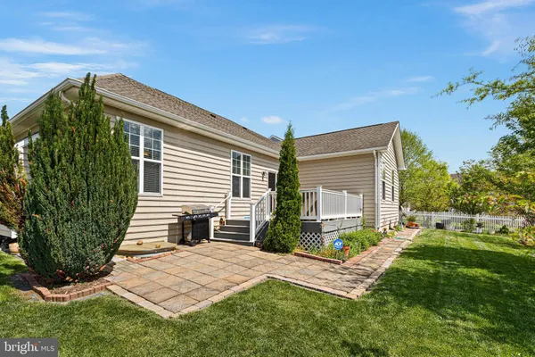 a front view of a house with a yard table and chairs