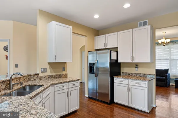 a kitchen with stainless steel appliances granite countertop a stove and a sink