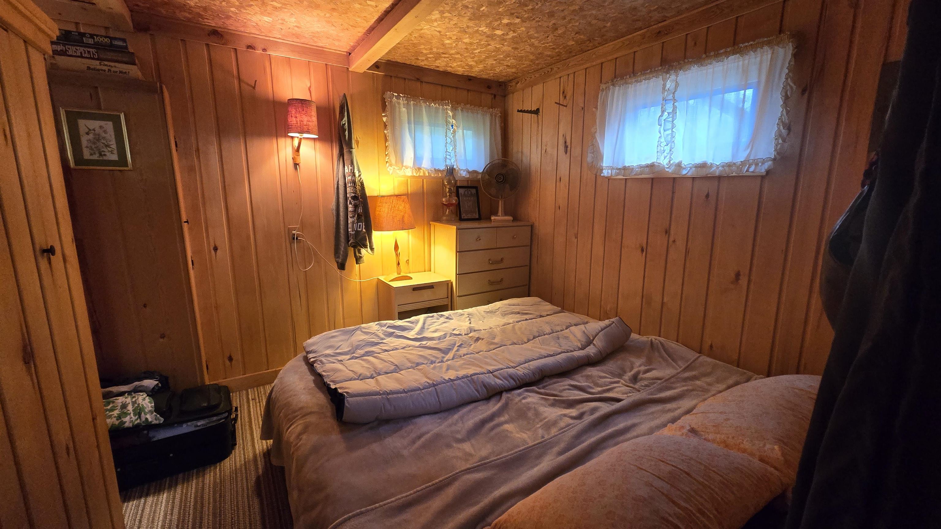 7178 Gold Mine Road Orr, MN 55771 - Photo 19 of 36 Bedroom with wooden walls and beamed ceiling