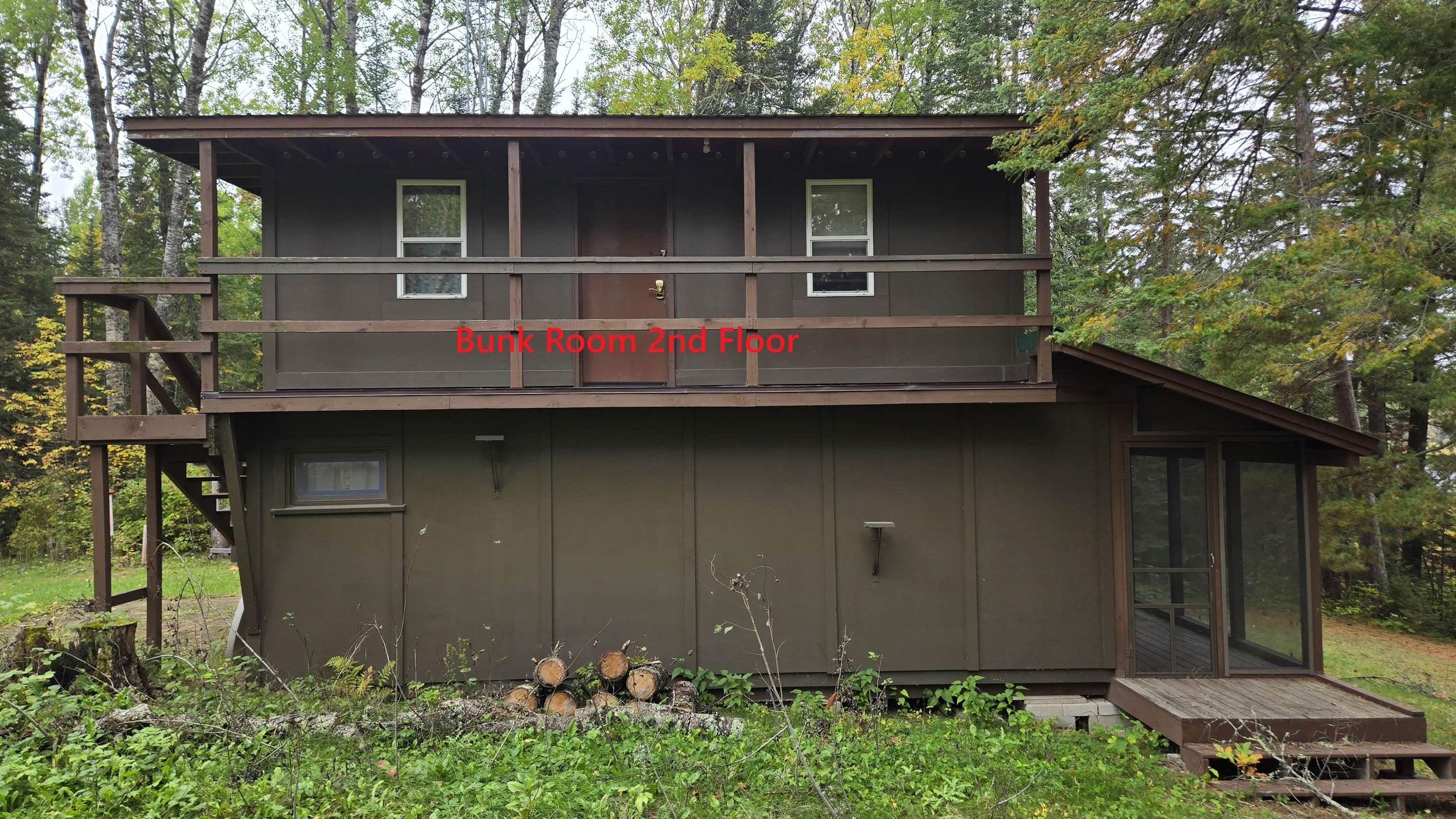 7178 Gold Mine Road Orr, MN 55771 - Photo 21 of 36 View of outbuilding featuring a sunroom, view of wooded area, and stairs