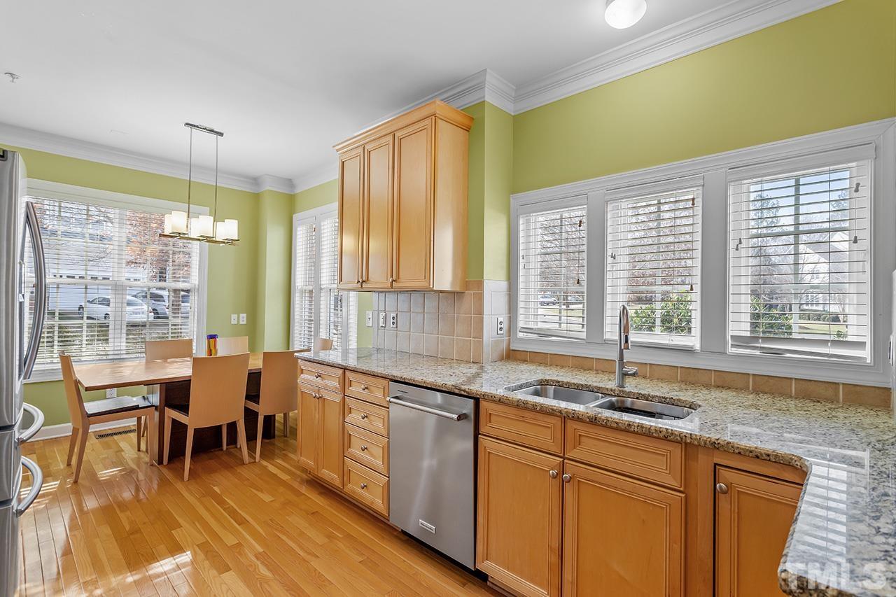 203 Towne Ridge Lane Chapel Hill, NC 27516 - Photo 11 of 38 a large kitchen with a large window and dining table