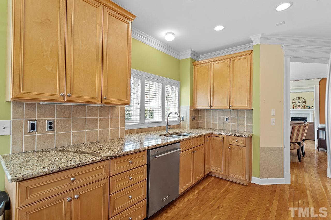 203 Towne Ridge Lane Chapel Hill, NC 27516 - Photo 13 of 38 a kitchen with stainless steel appliances granite countertop a sink a stove cabinets and wooden floor