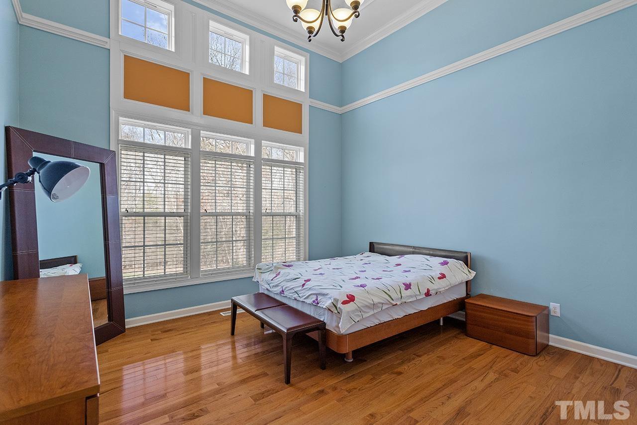 203 Towne Ridge Lane Chapel Hill, NC 27516 - Photo 16 of 38 a bedroom with a bed and wooden floor