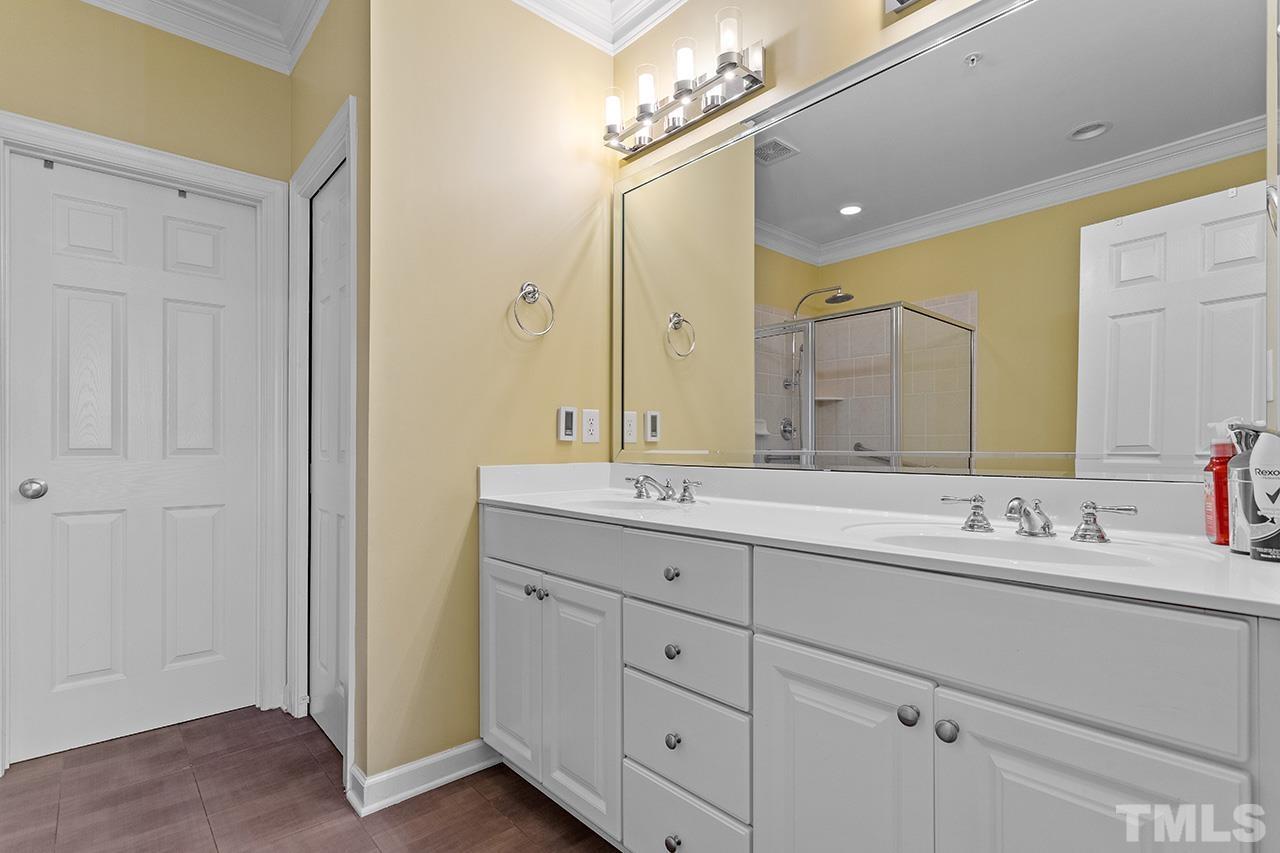 203 Towne Ridge Lane Chapel Hill, NC 27516 - Photo 18 of 38 a bathroom with double sink and a mirror