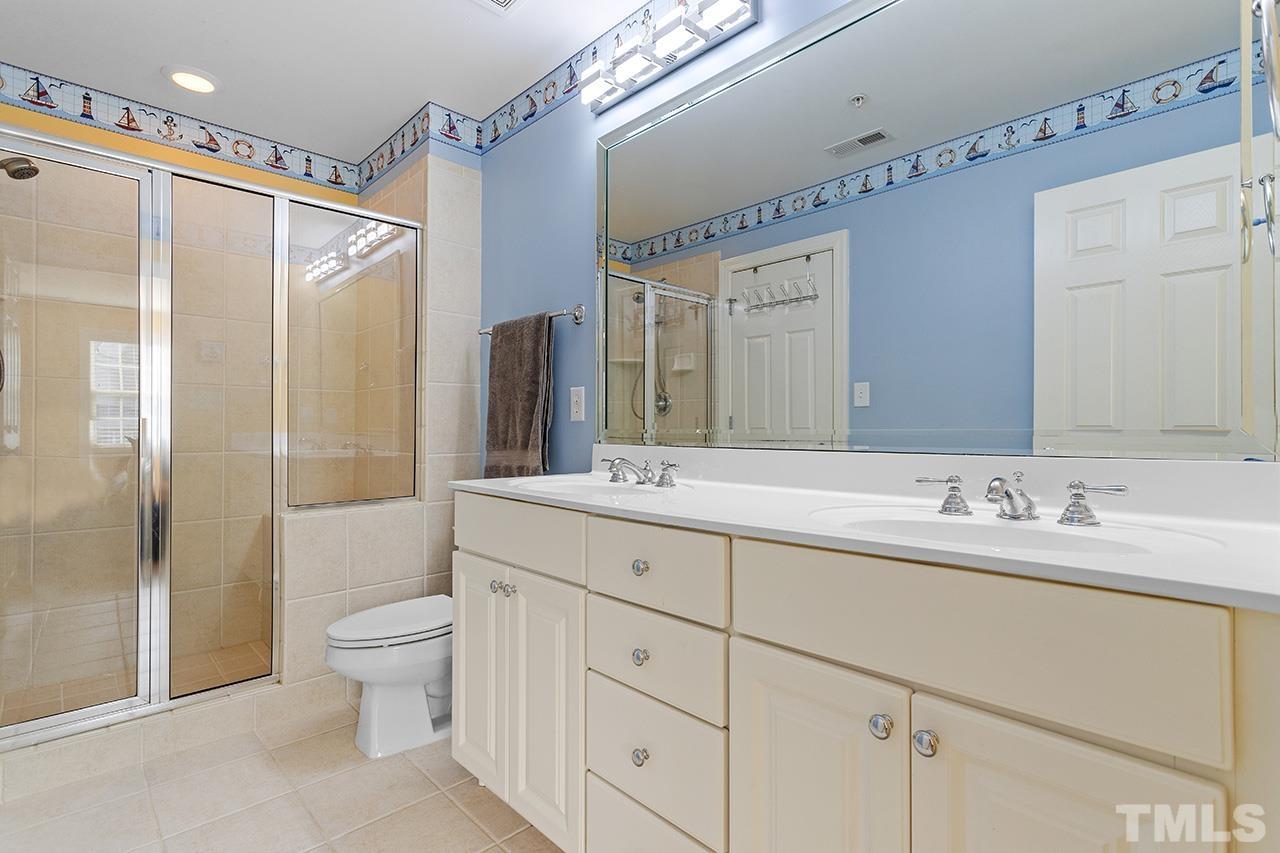 203 Towne Ridge Lane Chapel Hill, NC 27516 - Photo 27 of 38 a bathroom with a double vanity sink toilet and shower