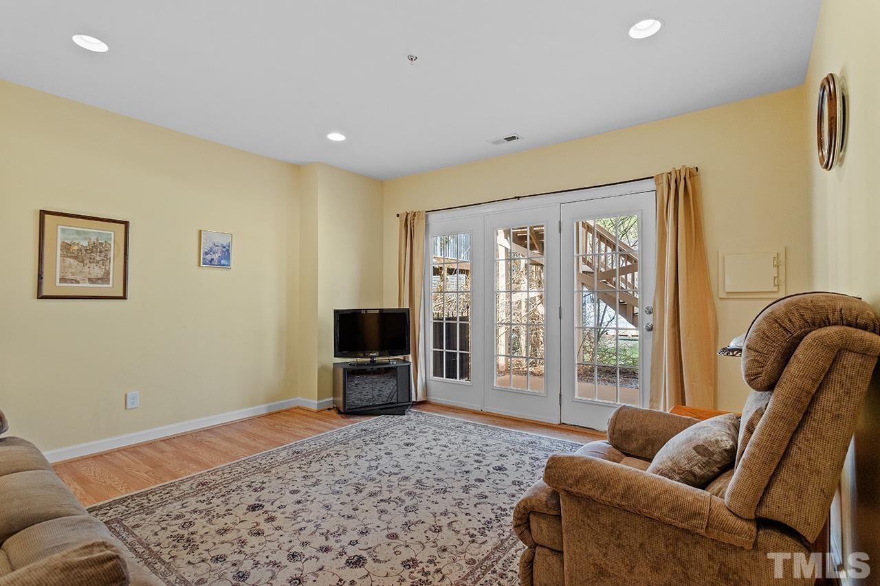 203 Towne Ridge Lane Chapel Hill, NC 27516 - Photo 33 of 38 a living room with furniture and a flat screen tv