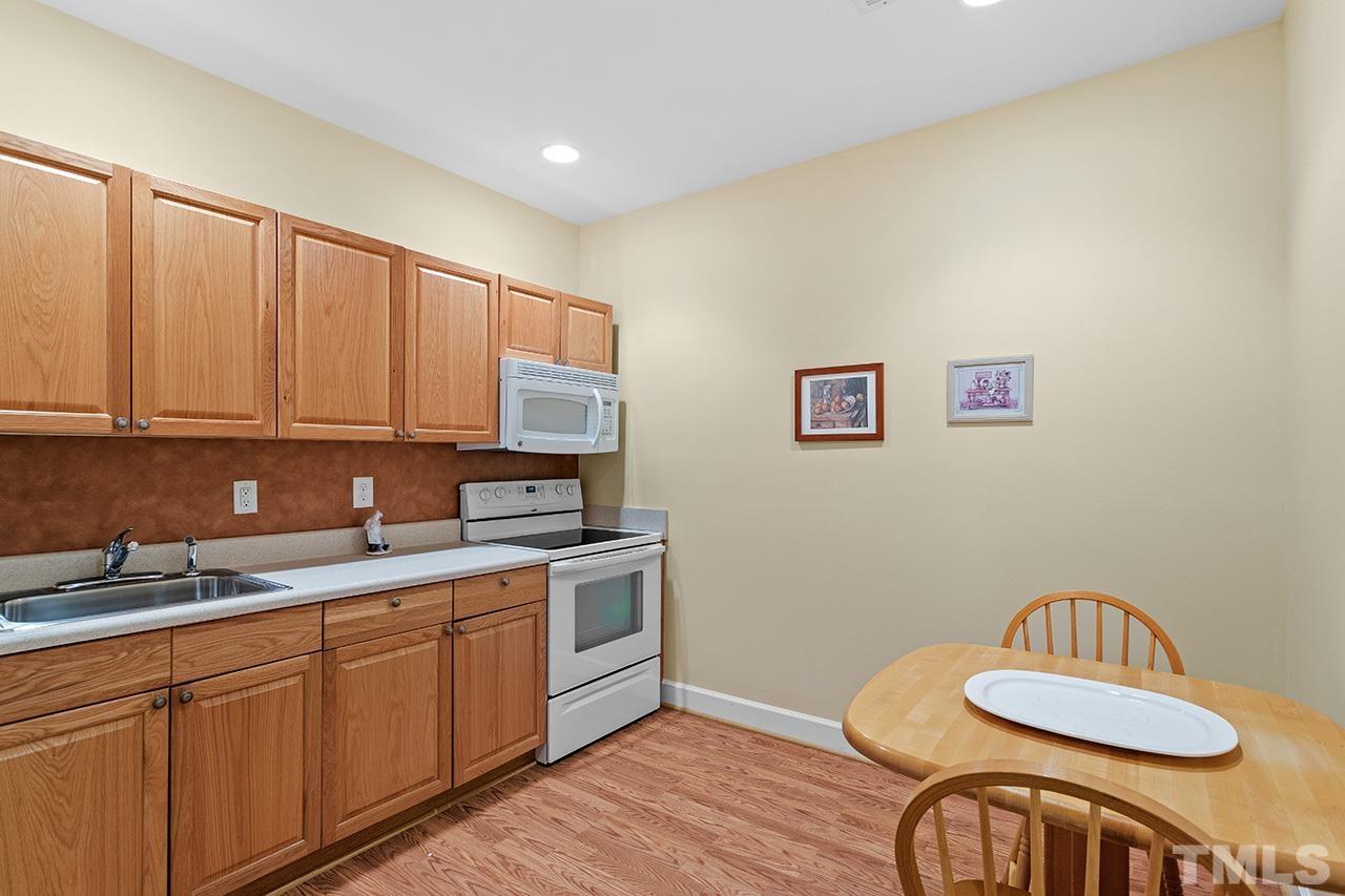 203 Towne Ridge Lane Chapel Hill, NC 27516 - Photo 35 of 38 a kitchen with sink cabinets and stove