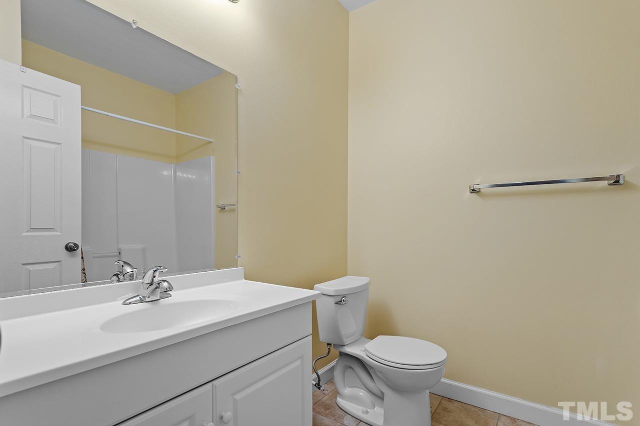 203 Towne Ridge Lane Chapel Hill, NC 27516 - Photo 37 of 38 a bathroom with a sink a toilet and a mirror