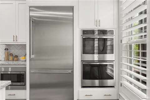 a kitchen with cabinets and stainless steel appliances