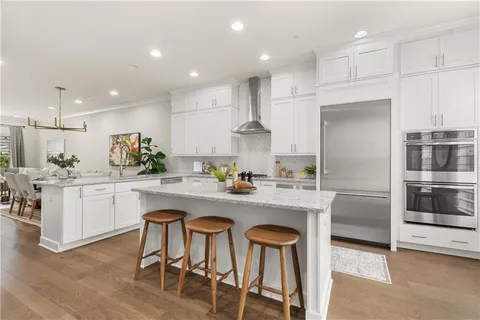 a kitchen with a sink stainless steel appliances and white cabinets