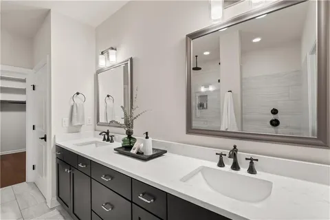 a bathroom with double sink and a mirror