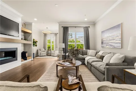 a living room with furniture fireplace and window