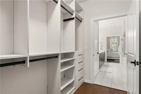 a view of a hallway with lots of frames on wall and staircase
