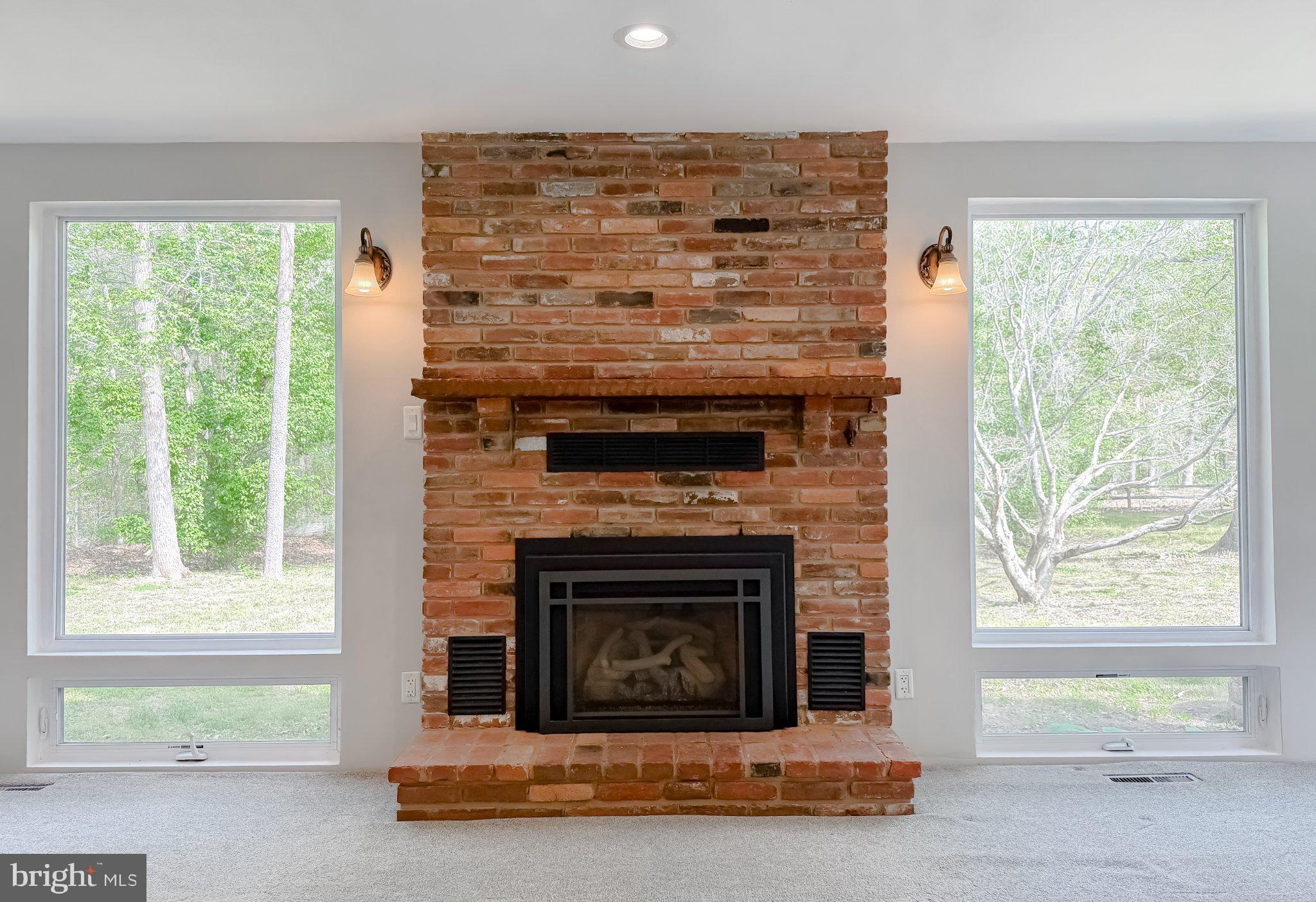 2420 Cecil Lane Huntingtown, MD 20639 - Photo 11 of 72 Cozy brick fireplace with nature views.