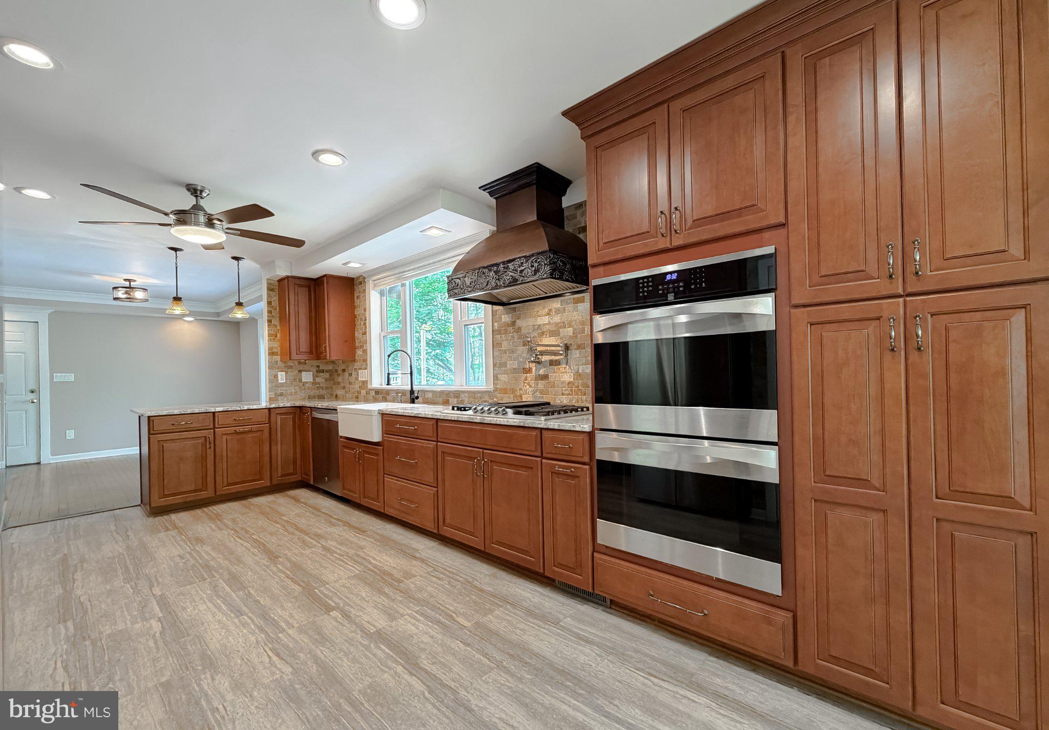 2420 Cecil Lane Huntingtown, MD 20639 - Photo 15 of 72 Modern kitchen with rich wood cabinetry.