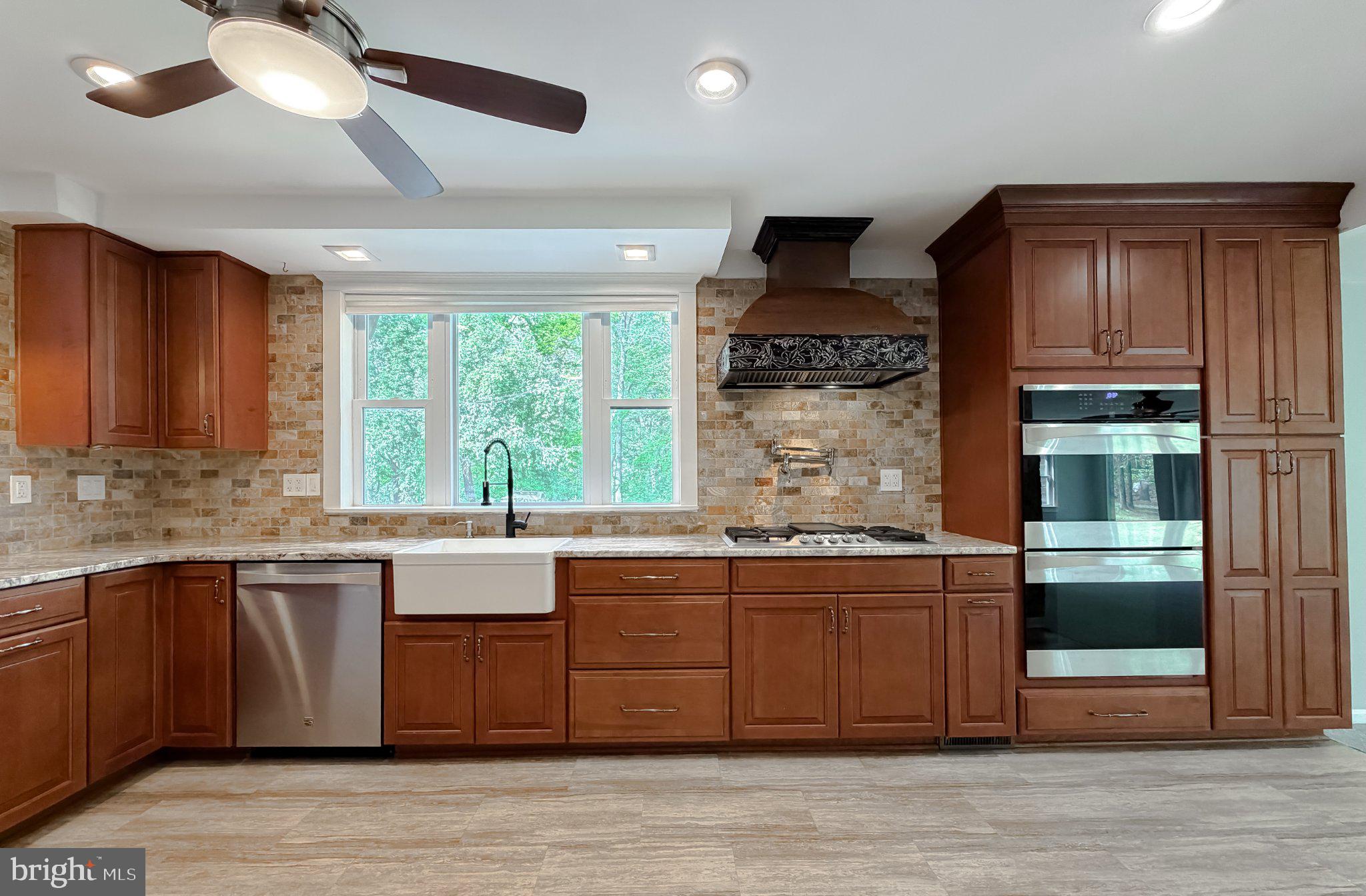 2420 Cecil Lane Huntingtown, MD 20639 - Photo 19 of 72 Modern kitchen with rich wood tones.
