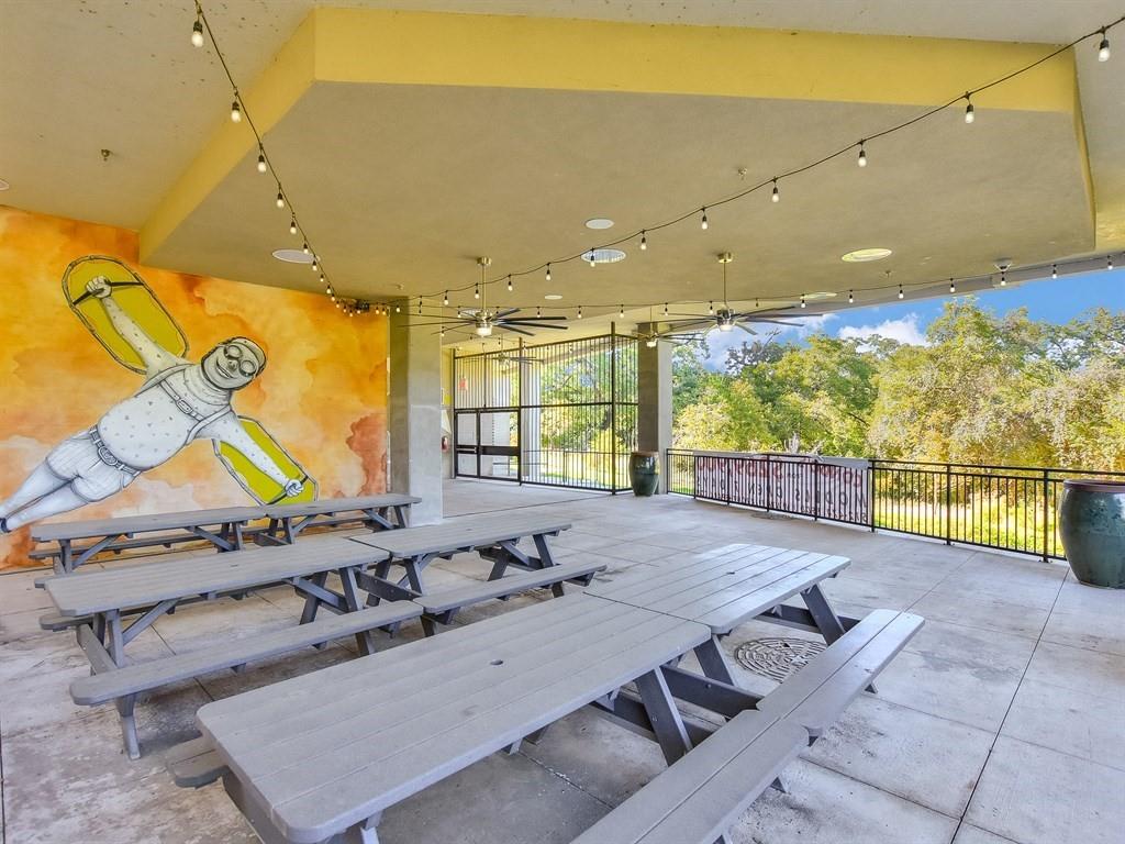 1900 Barton Springs Road, Unit 5009 Austin, TX 78704 - Photo 34 of 35 An inviting covered patio offers ample seating with a serene wooded backdrop.