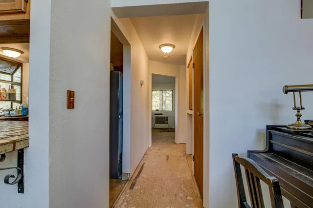 a bedroom with a large bed and a flat tv screen