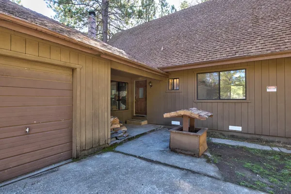 a view of a livingroom with wooden floor and a bathroom