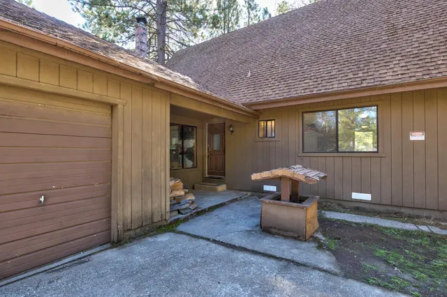 a view of a livingroom with wooden floor and a bathroom