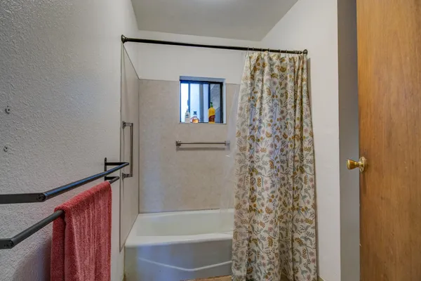 an empty room with closet and a chandelier fan