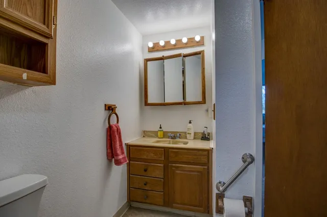 an empty room with a ceiling fan and window