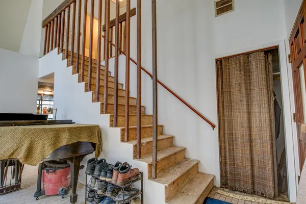 a view of a house with a yard and large tree