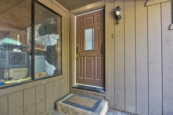 a living room with furniture a rug a fireplace and windows