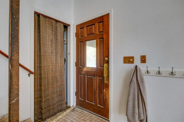 a living room with furniture a fireplace and a table
