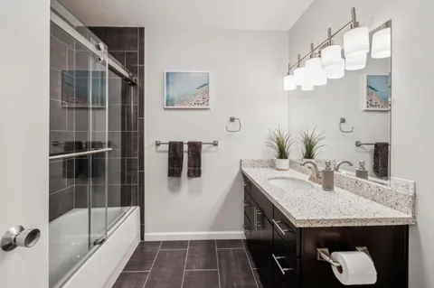 a bathroom with a shower and a sink