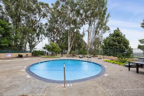 a view of a swimming pool with an outdoor space and seating area