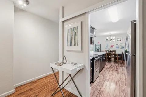 a kitchen with stainless steel appliances a sink cabinets and wooden floor