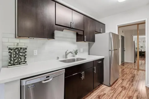 a kitchen with a sink stove and cabinets