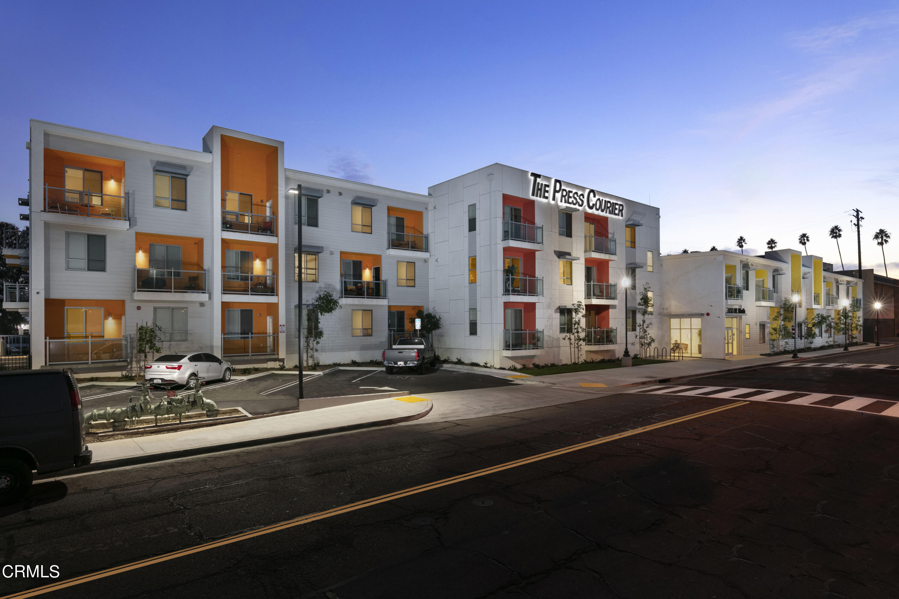 a city street lined with tall buildings and a street