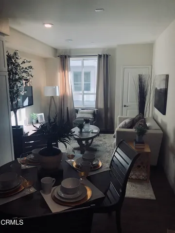 a living room with furniture a rug and a window