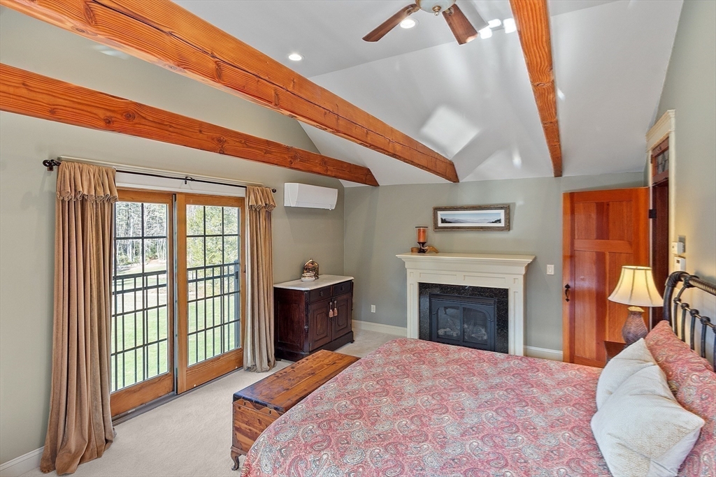 360 Teel Road Winchendon, MA 01475 - Photo 23 of 42 a bedroom with a bed and a fireplace