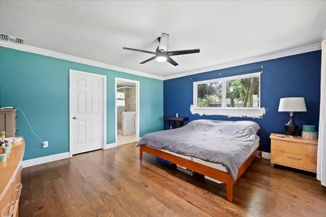 a bedroom with a large bed and a chandelier