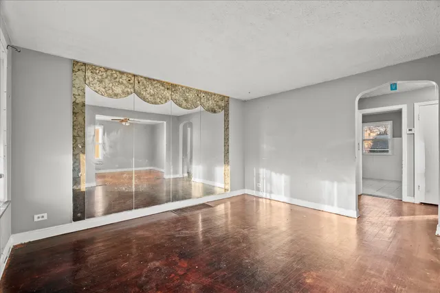 an empty room with a window and a ceiling fan