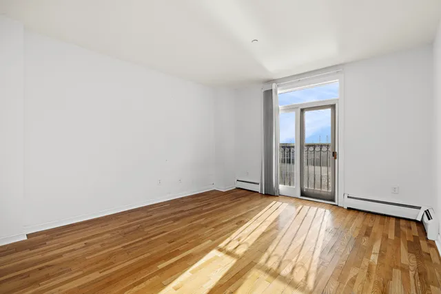 a view of an empty room and wooden floor