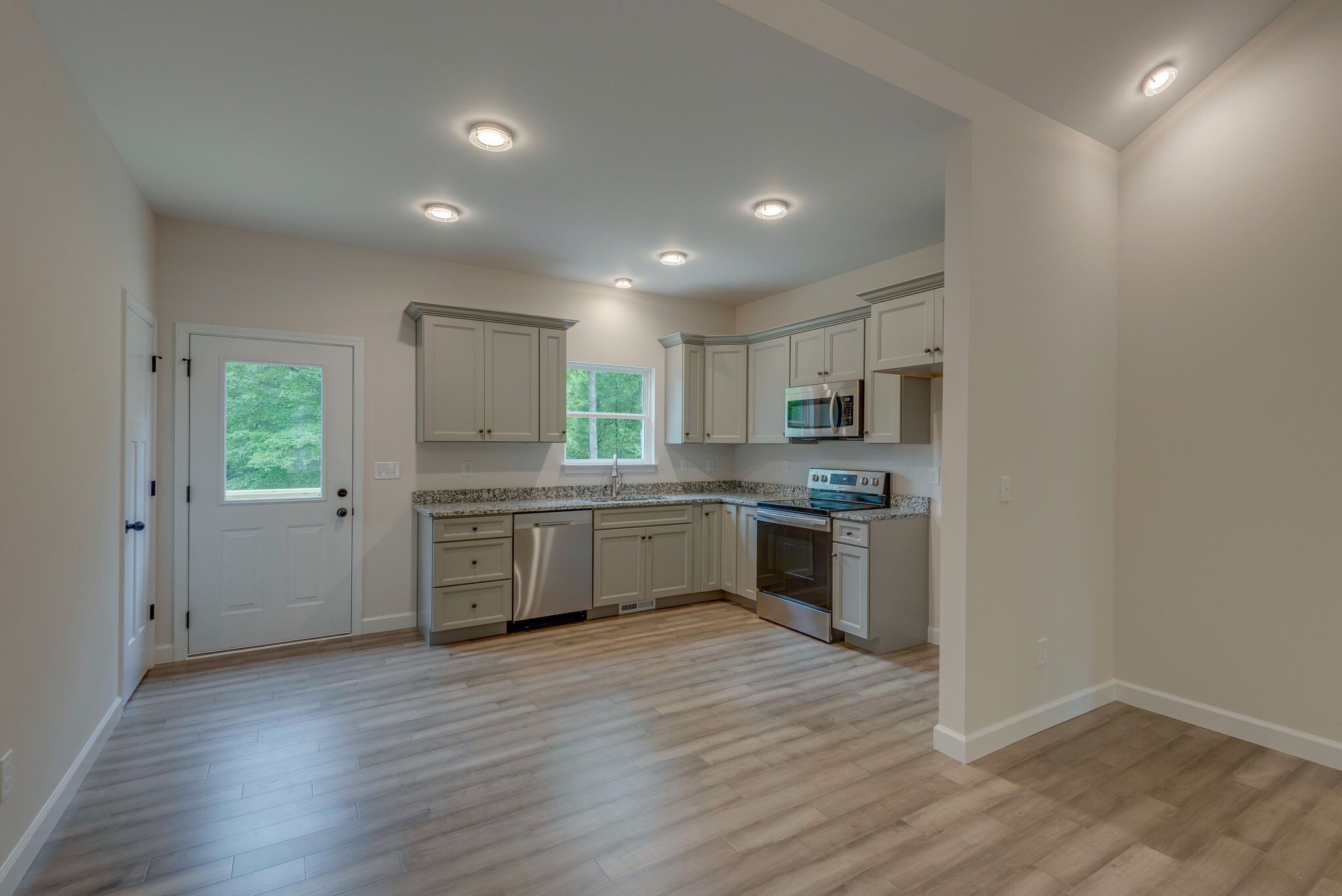 1170 Cowan Road Dickson, TN 37055 - Photo 11 of 30 a kitchen with granite countertop a sink cabinets and stainless steel appliances