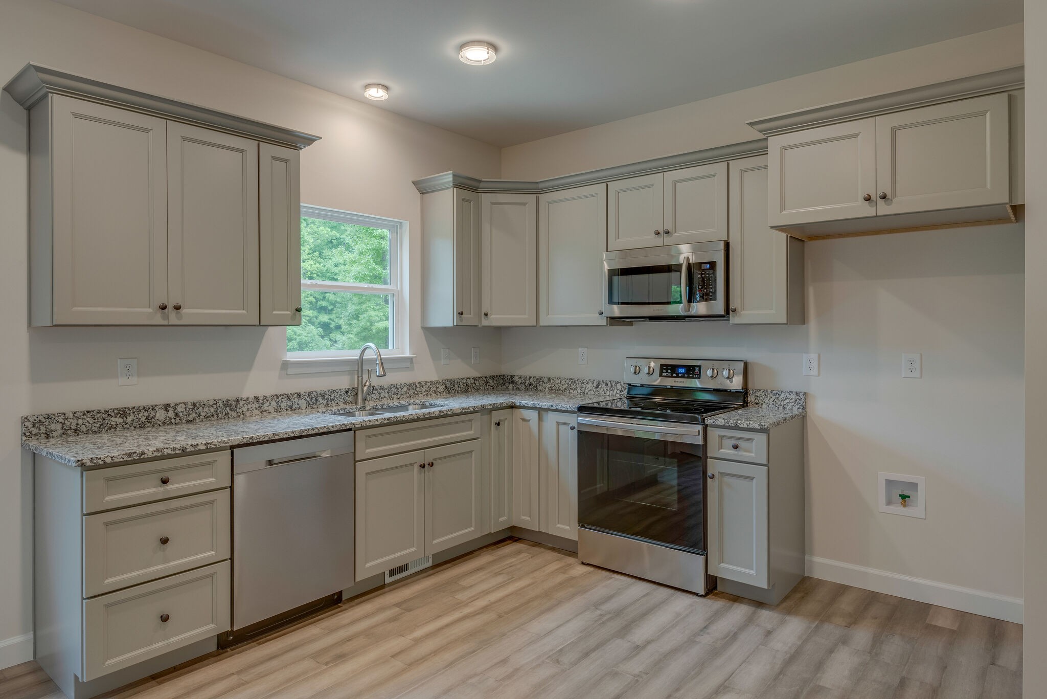1170 Cowan Road Dickson, TN 37055 - Photo 12 of 30 a kitchen with granite countertop white cabinets white stainless steel appliances and a sink