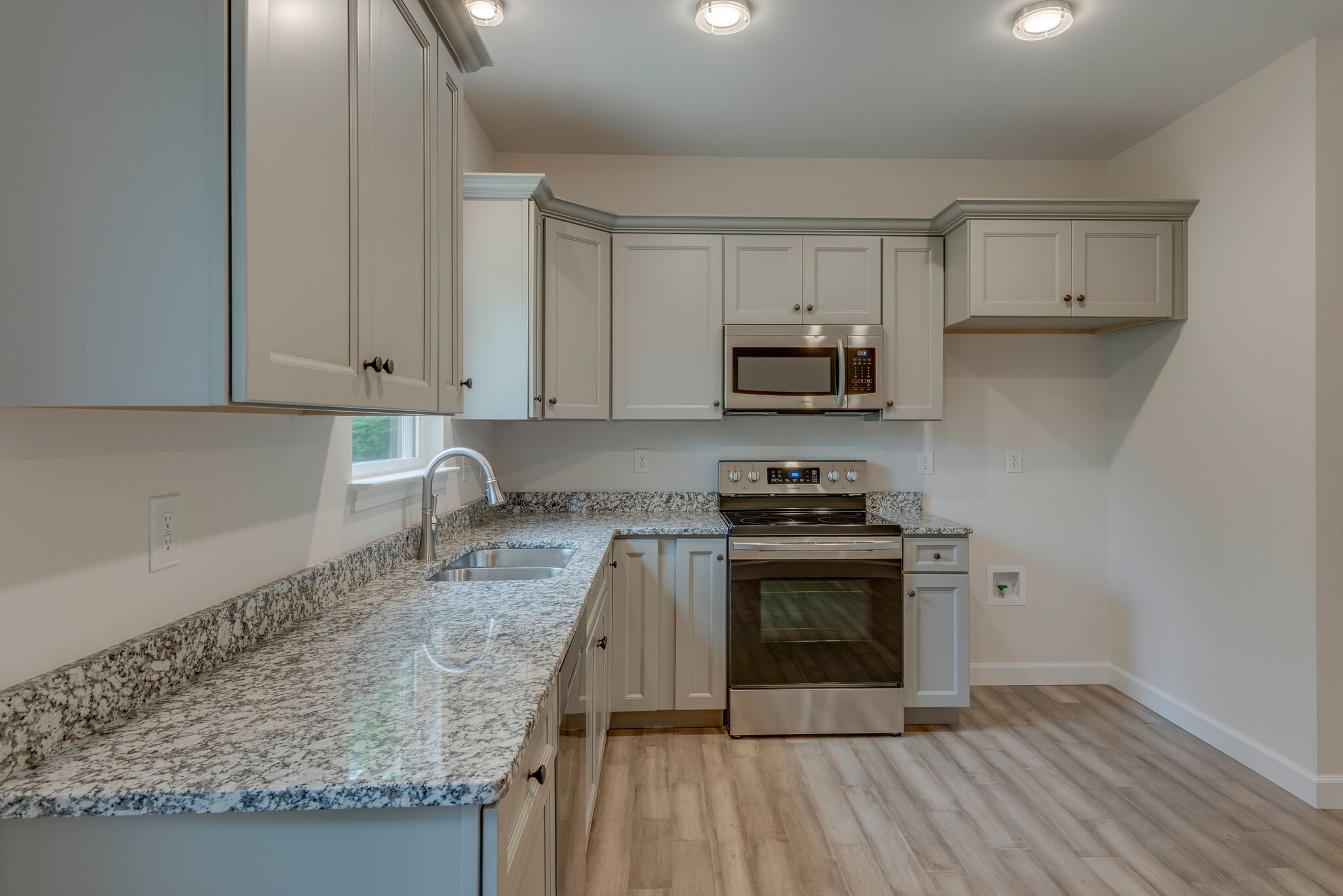 1170 Cowan Road Dickson, TN 37055 - Photo 13 of 30 a kitchen with stainless steel appliances granite countertop a stove a sink and a microwave