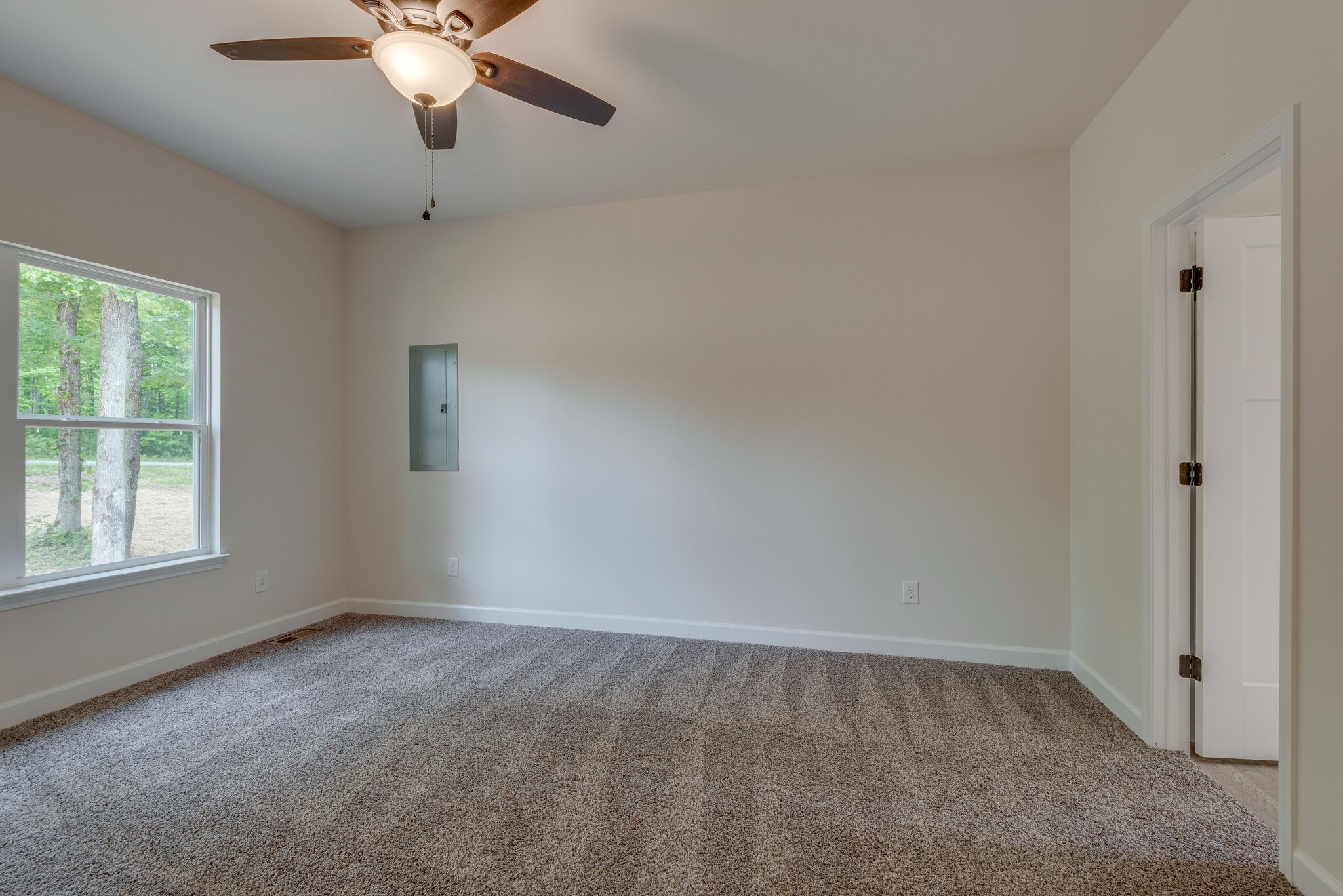 1170 Cowan Road Dickson, TN 37055 - Photo 15 of 30 an empty room with a chandelier fan and windows