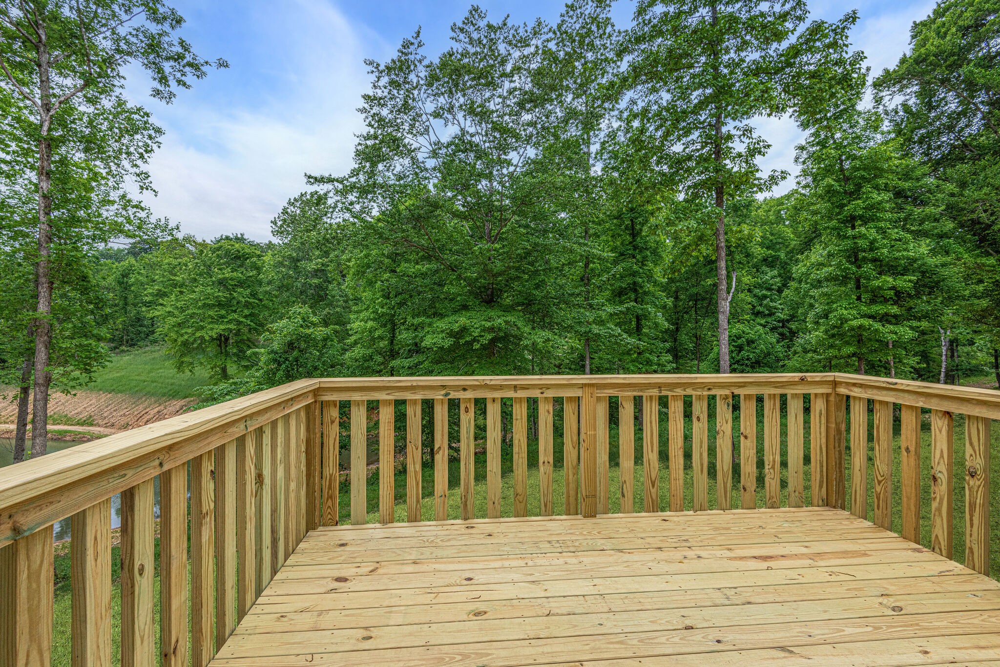 1170 Cowan Road Dickson, TN 37055 - Photo 26 of 30 a balcony view with wooden floor and trees in the background
