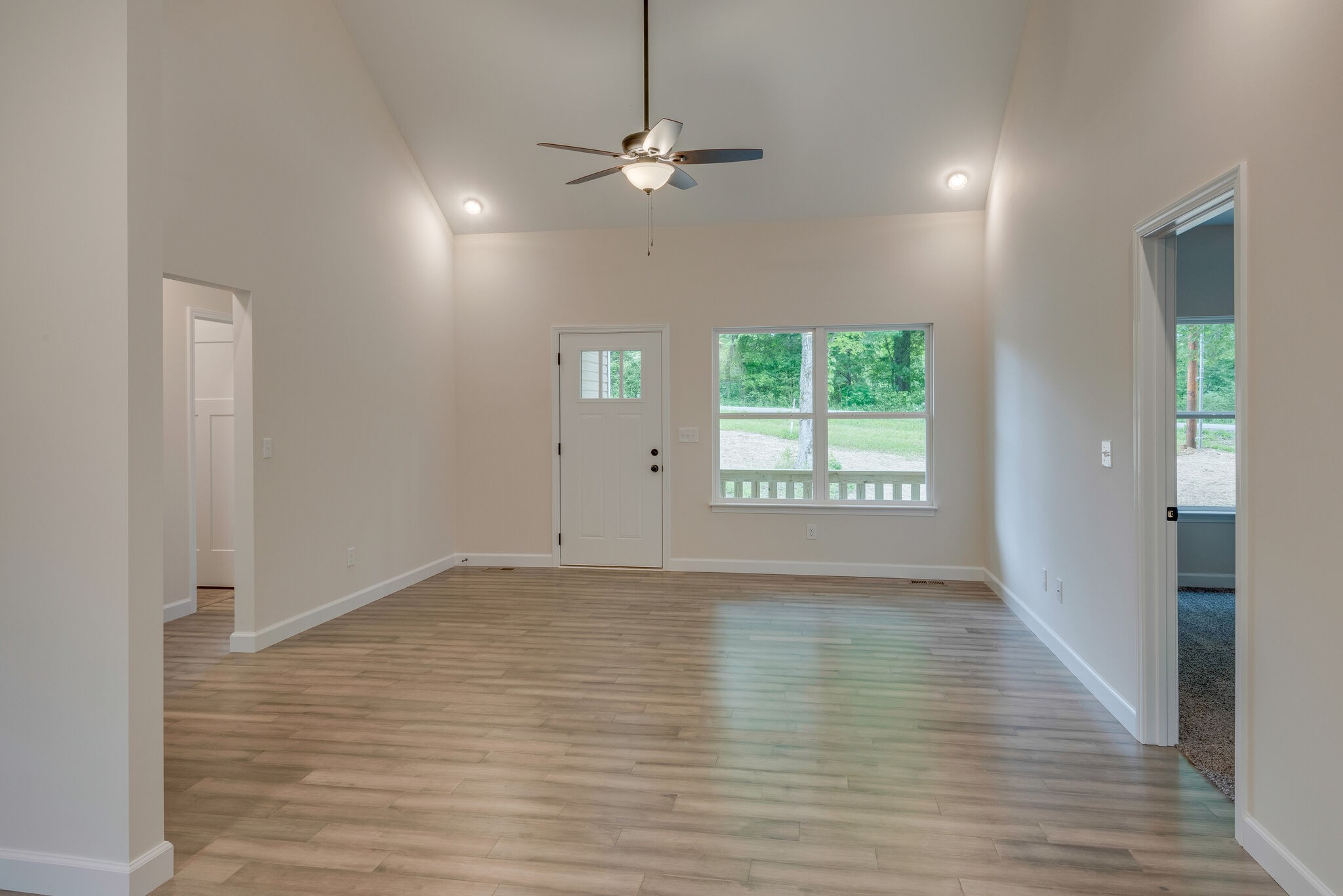 1170 Cowan Road Dickson, TN 37055 - Photo 4 of 30 a view of an empty room with wooden floor and a window