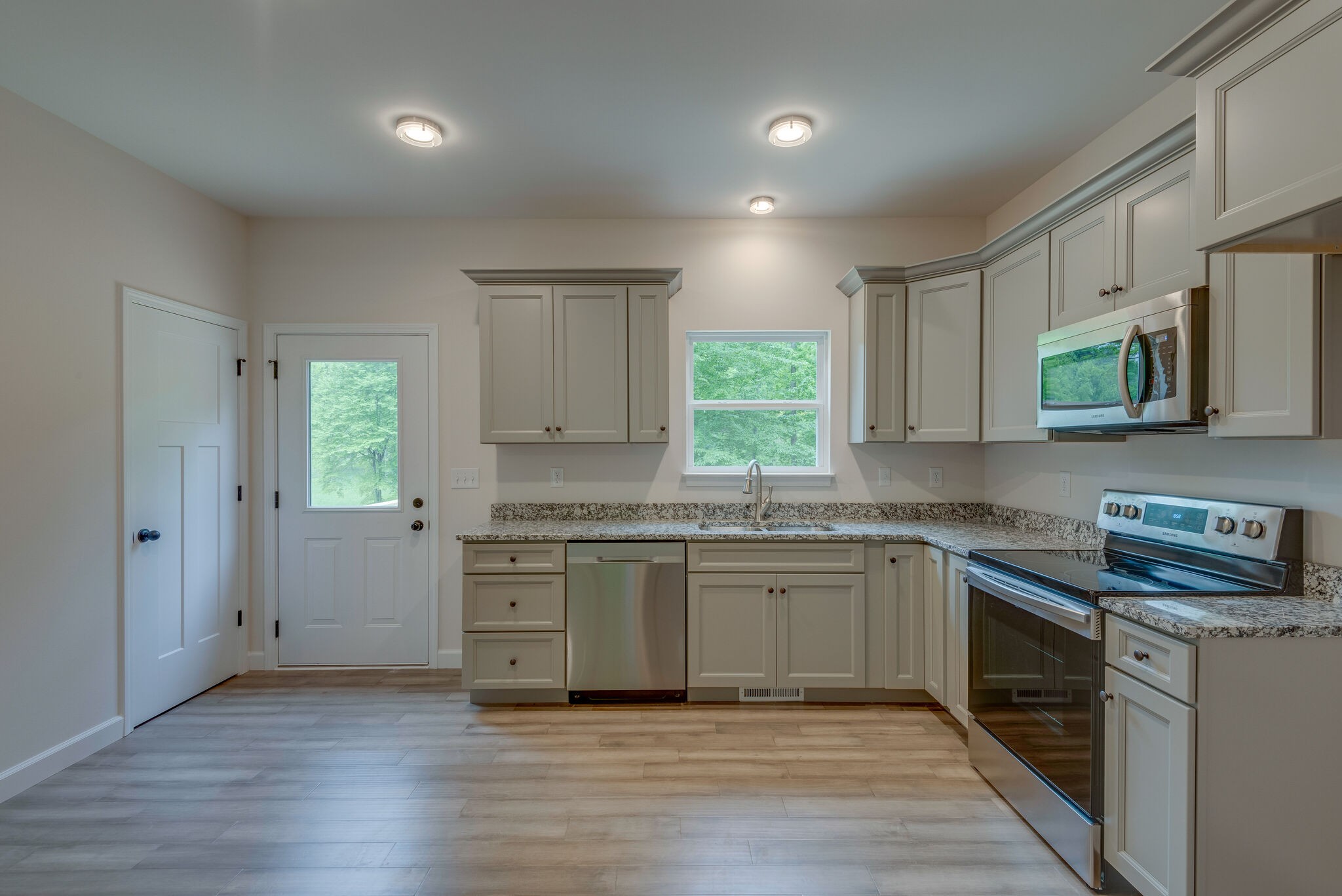 1170 Cowan Road Dickson, TN 37055 - Photo 8 of 30 a kitchen with granite countertop cabinets stainless steel appliances a sink and a window