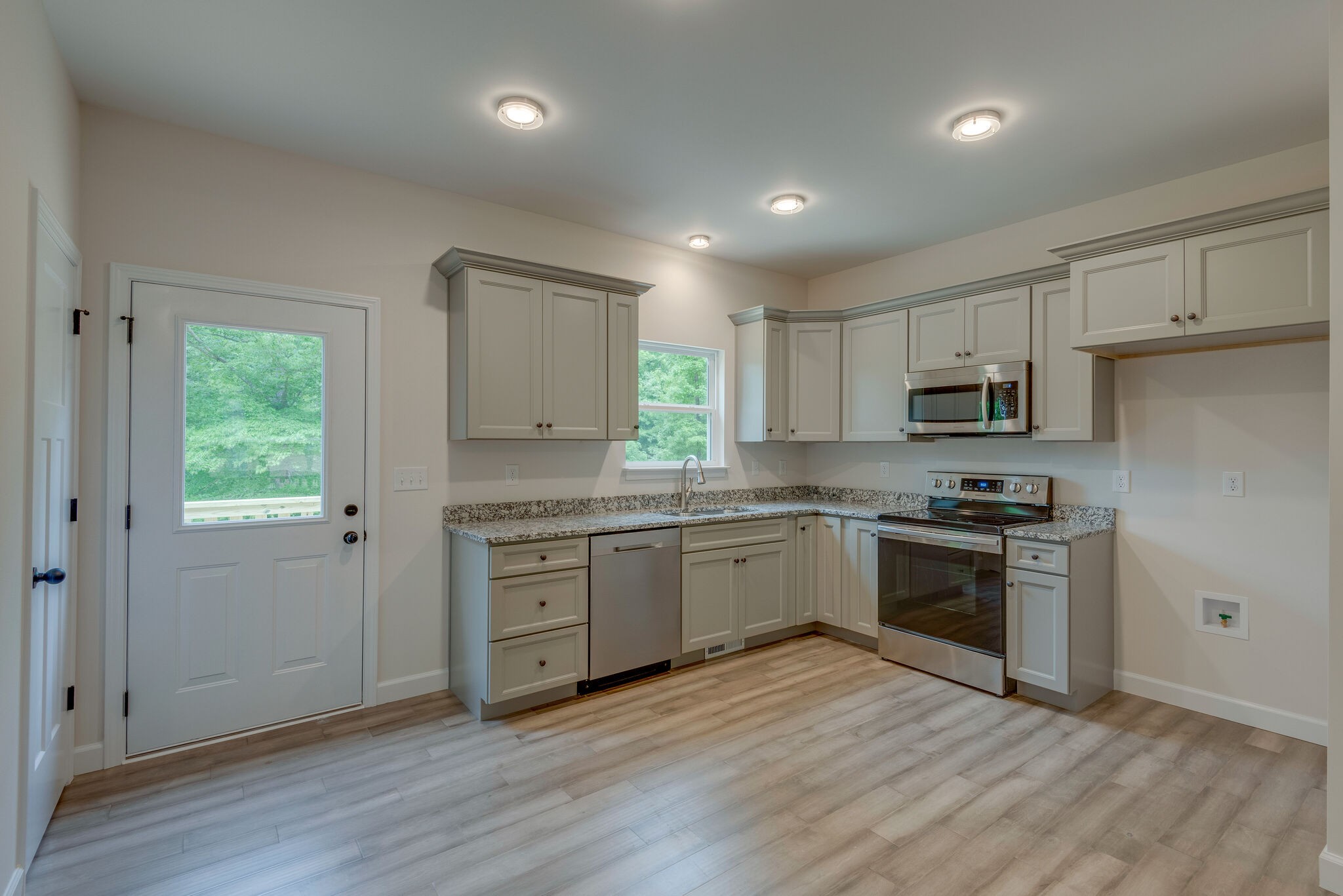 1170 Cowan Road Dickson, TN 37055 - Photo 9 of 30 a kitchen with granite countertop a stove top oven sink and cabinets