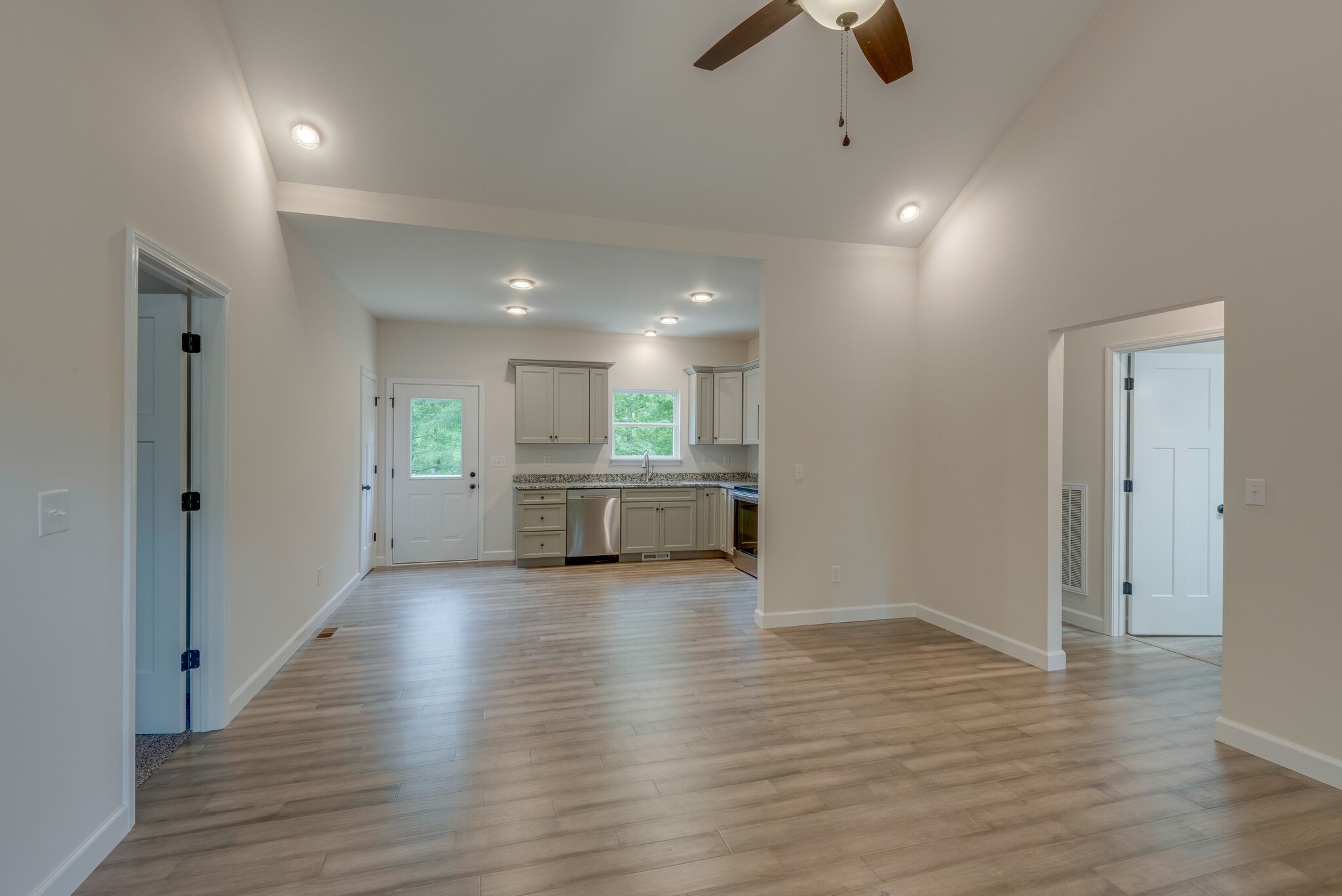 1170 Cowan Road Dickson, TN 37055 - Photo 10 of 30 a view of an empty room with wooden floor kitchen view and a window
